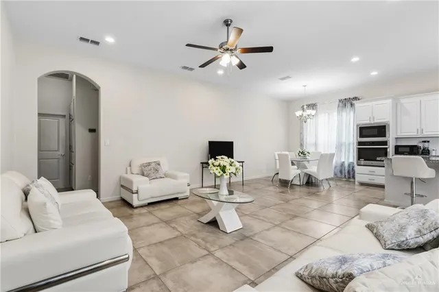a living room with furniture and kitchen view
