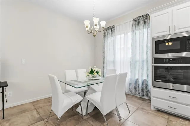 a view of a dining room with furniture and chandelier