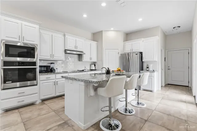 a kitchen with a sink cabinets and stainless steel appliances