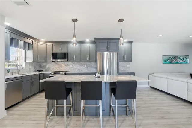 a living room with furniture a rug and a chandelier
