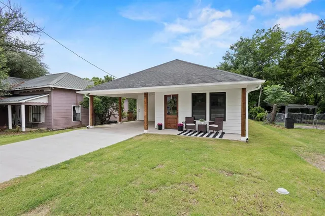 a view of a house with a yard porch and sitting area