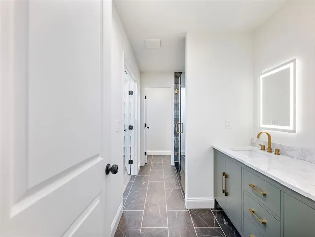 a bathroom with a double vanity sink mirror and