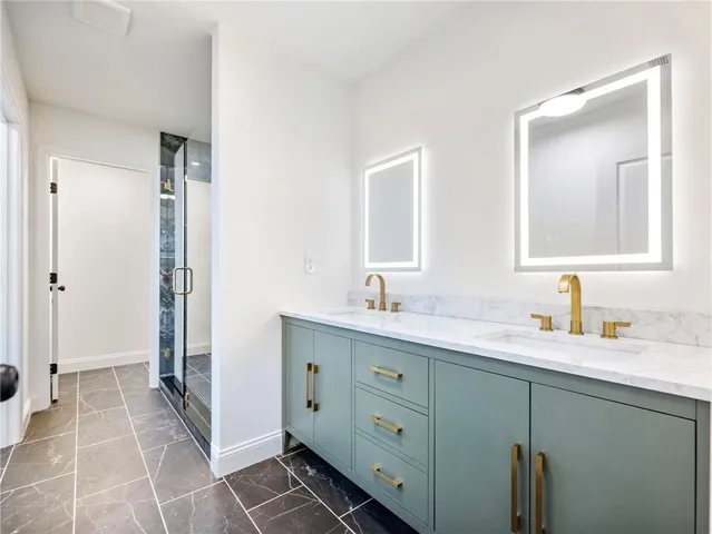 a bathroom with a double vanity sink and mirror
