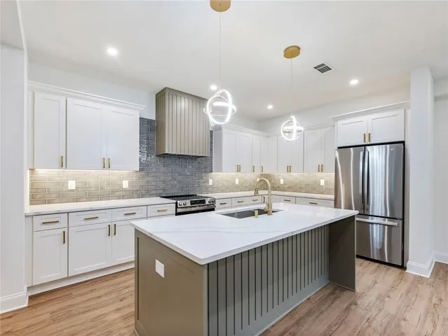 a kitchen with a sink stove and cabinets