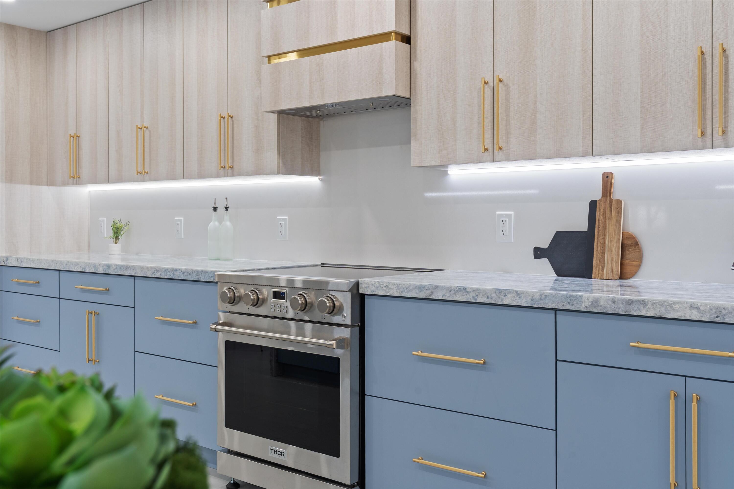 21766 Beachnut Drive Boca Raton, FL 33433 - Photo 17 of 64 a kitchen with granite countertop white cabinets and white appliances