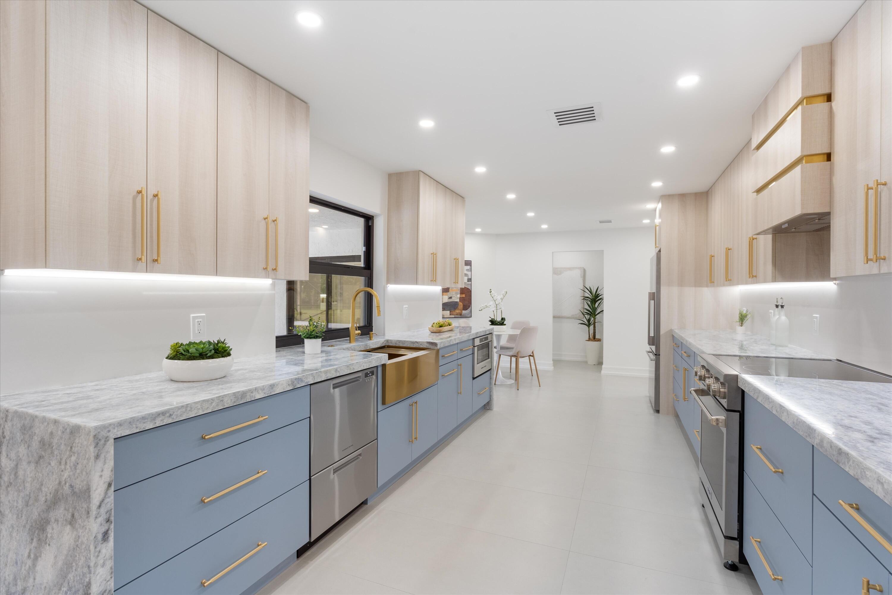 21766 Beachnut Drive Boca Raton, FL 33433 - Photo 18 of 64 a kitchen with a sink stove and cabinets