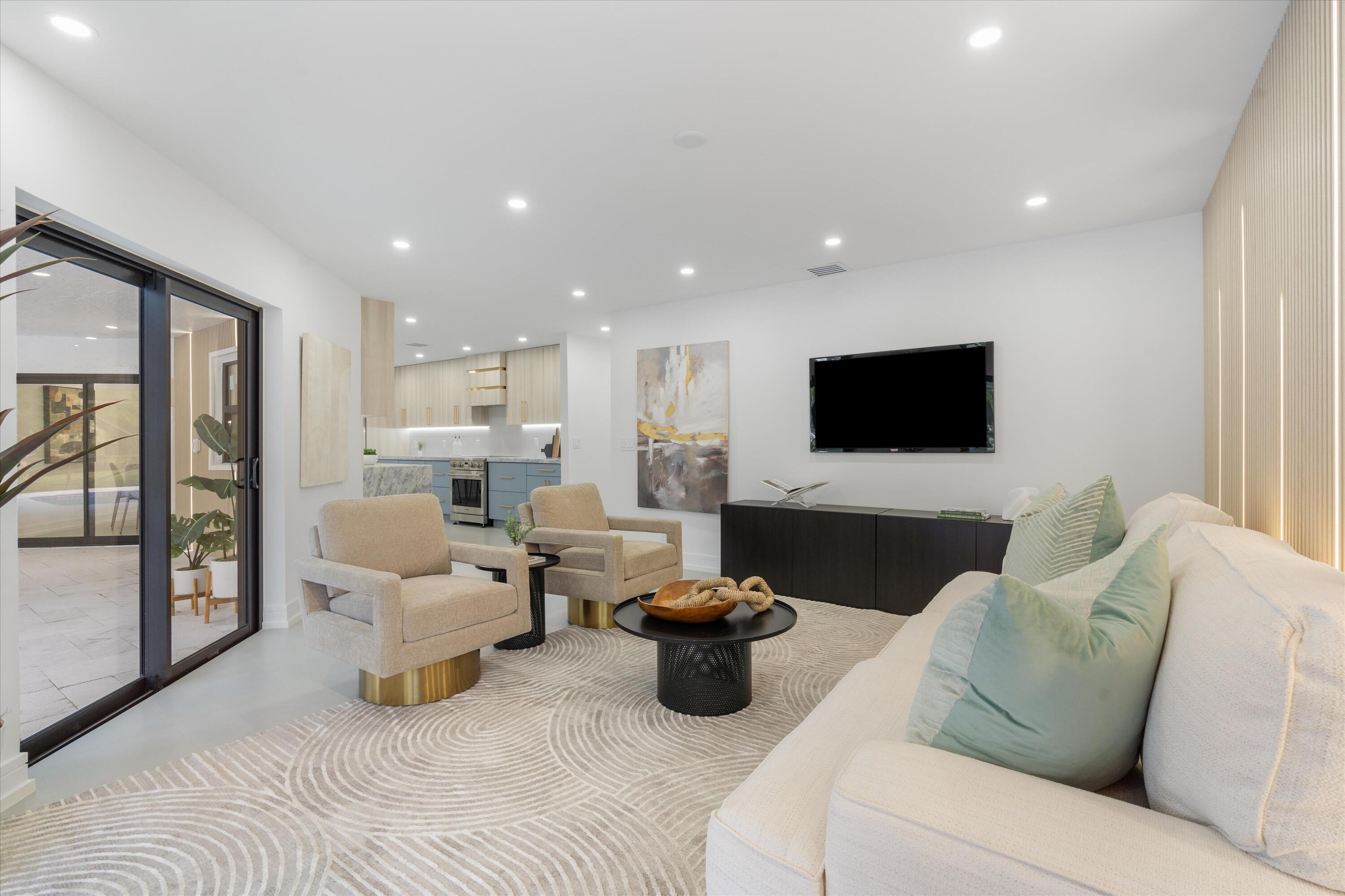 21766 Beachnut Drive Boca Raton, FL 33433 - Photo 24 of 64 a living room with furniture and a flat screen tv
