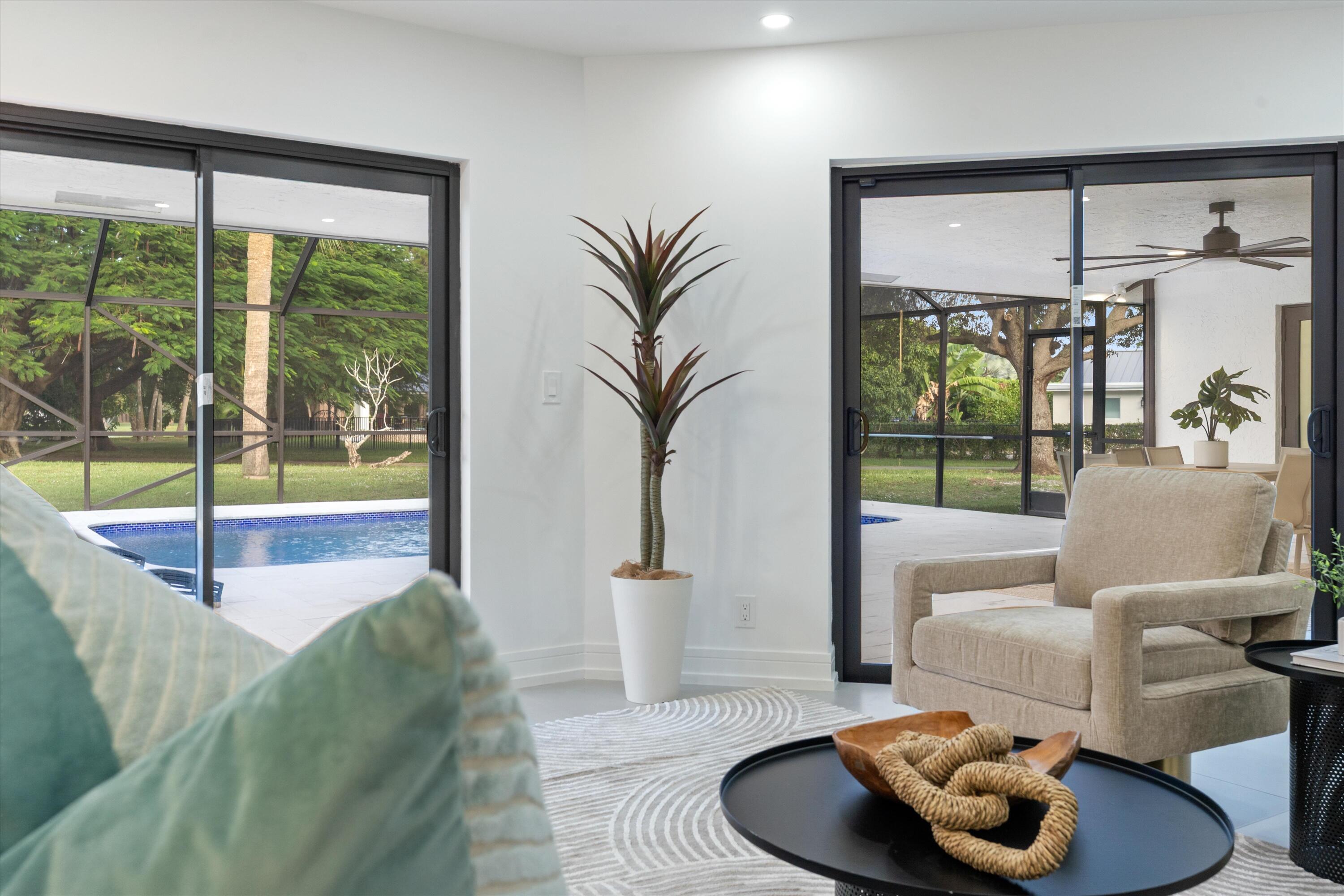 21766 Beachnut Drive Boca Raton, FL 33433 - Photo 26 of 64 a living room with furniture and a floor to ceiling window