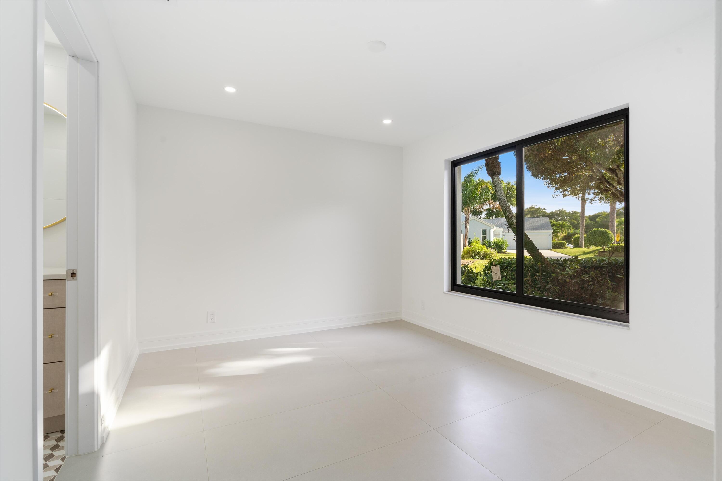 21766 Beachnut Drive Boca Raton, FL 33433 - Photo 39 of 64 a view of a hallway with a large window in a room