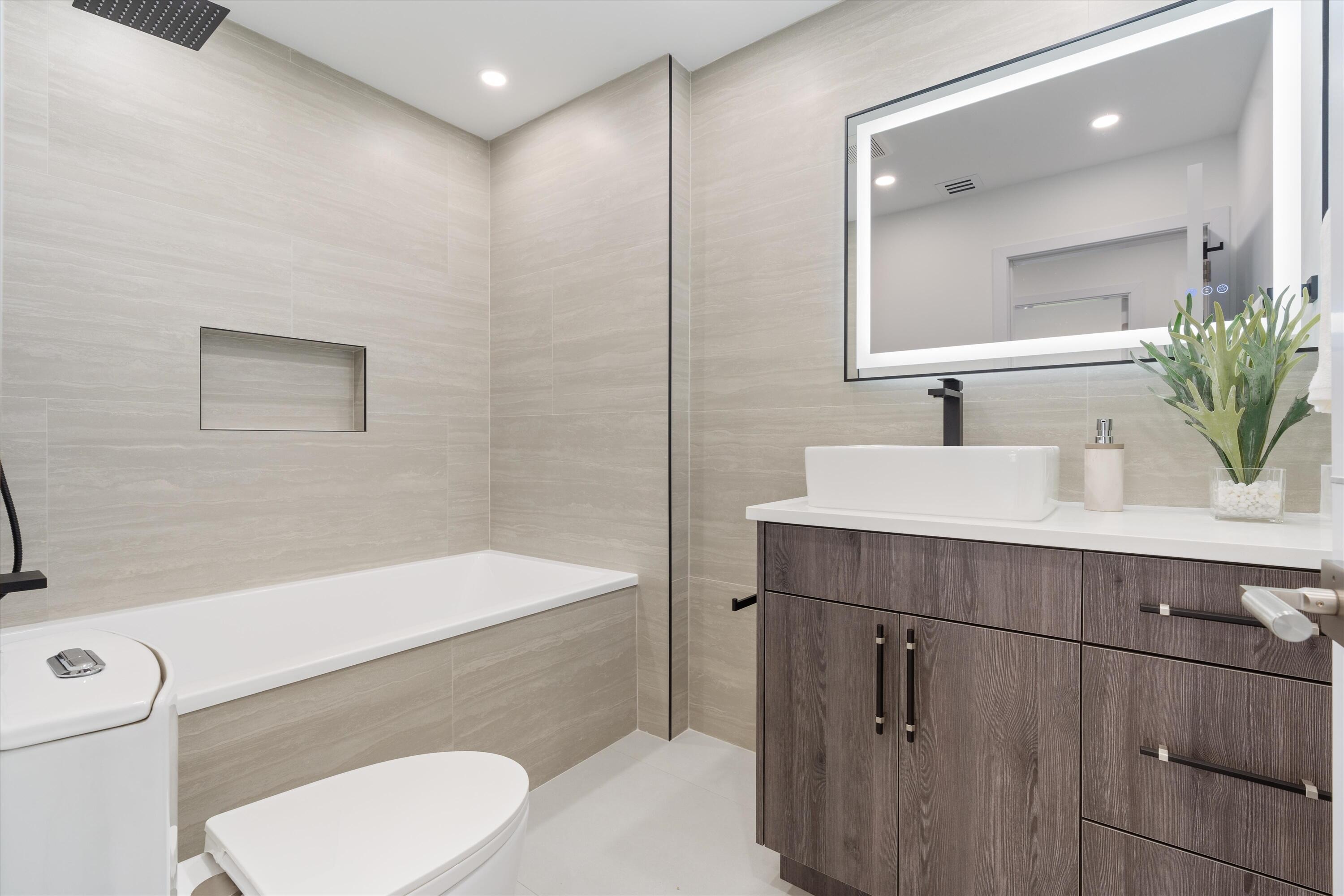 21766 Beachnut Drive Boca Raton, FL 33433 - Photo 44 of 64 a bathroom with a sink and a mirror