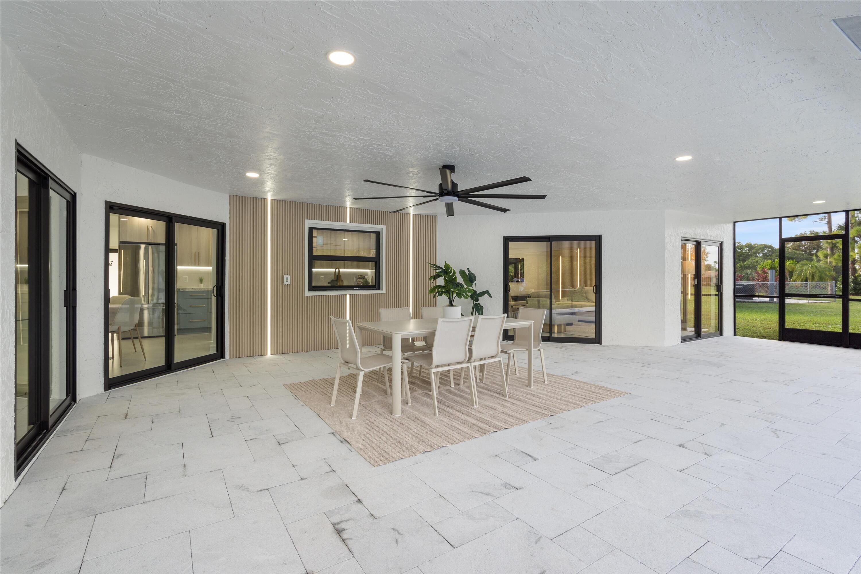 21766 Beachnut Drive Boca Raton, FL 33433 - Photo 5 of 64 a view of a livingroom with furniture a floor to ceiling window and kitchen