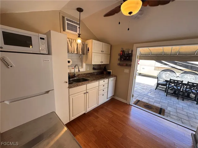 a view of a patio with table and chairs under an umbrella