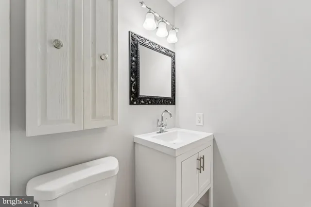 a bathroom with a toilet sink and mirror