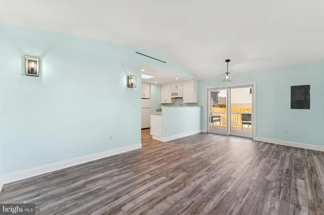 a view of a kitchen with wooden floor and a kitchen