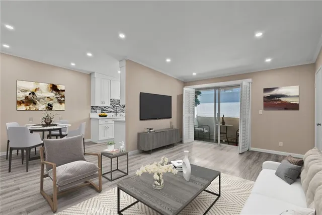a living room with furniture a rug and a flat screen tv