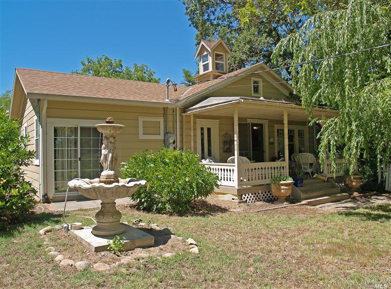 a view of a house with yard and sitting area