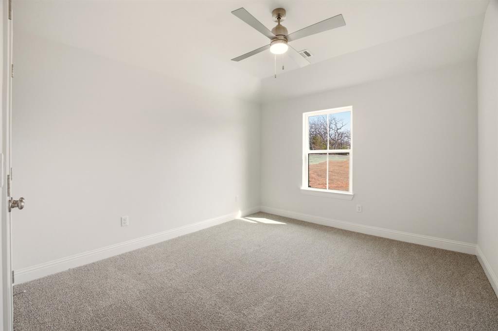 2017 Forest Bridge Azle, TX 76020 - Photo 23 of 30 an empty room with a window and ceiling fan
