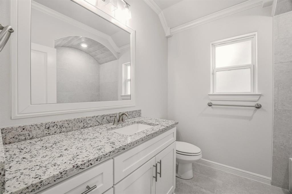 2017 Forest Bridge Azle, TX 76020 - Photo 25 of 30 a bathroom with a granite countertop toilet a sink and mirror