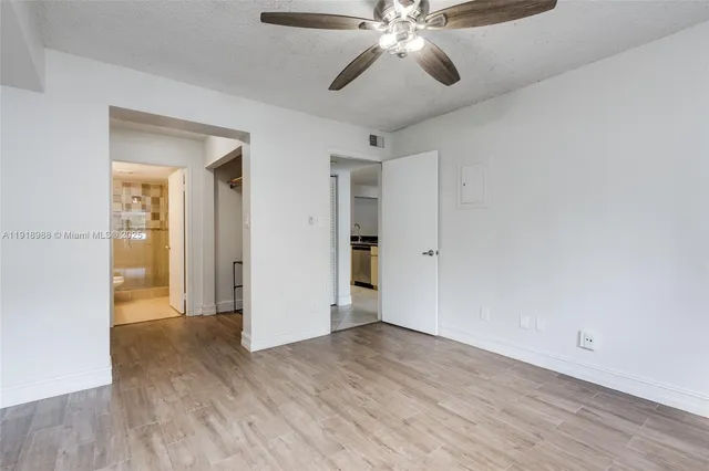 a view of an empty room and wooden floor