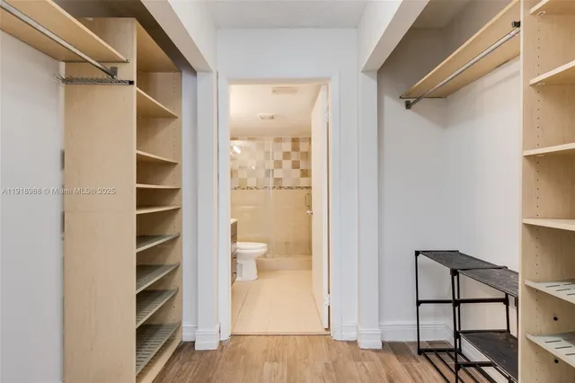 a view of walk in closet with empty racks