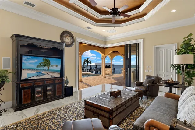 a kitchen with stainless steel appliances granite countertop a stove a refrigerator a sink a dining table and chairs with wooden floor