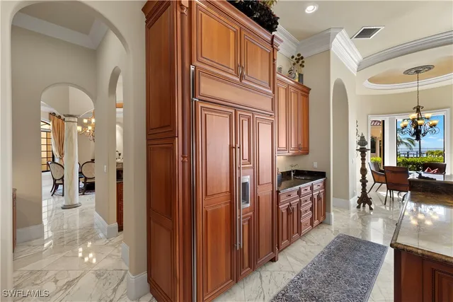 a kitchen with stainless steel appliances granite countertop a sink a stove and a wooden cabinets