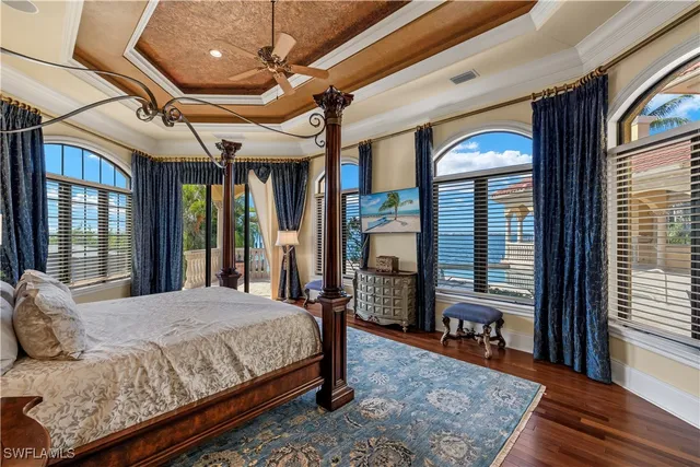 a spacious bedroom with a bed and dresser with mirror