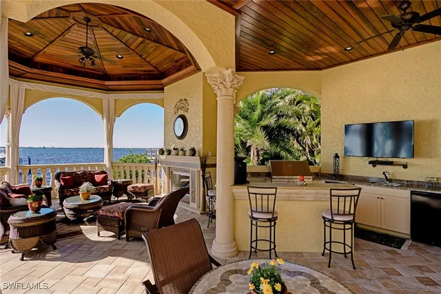 a view of a patio with dining table and chairs with a small yard