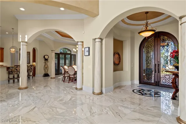 a view of a dining room with furniture and chandelier
