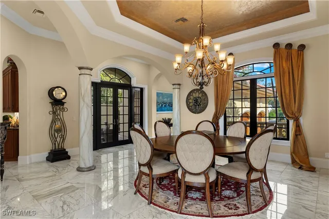 a view of a dining room with furniture and a chandelier