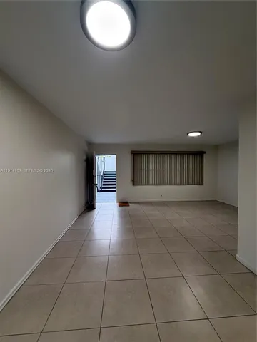 a view of empty room with a fireplace