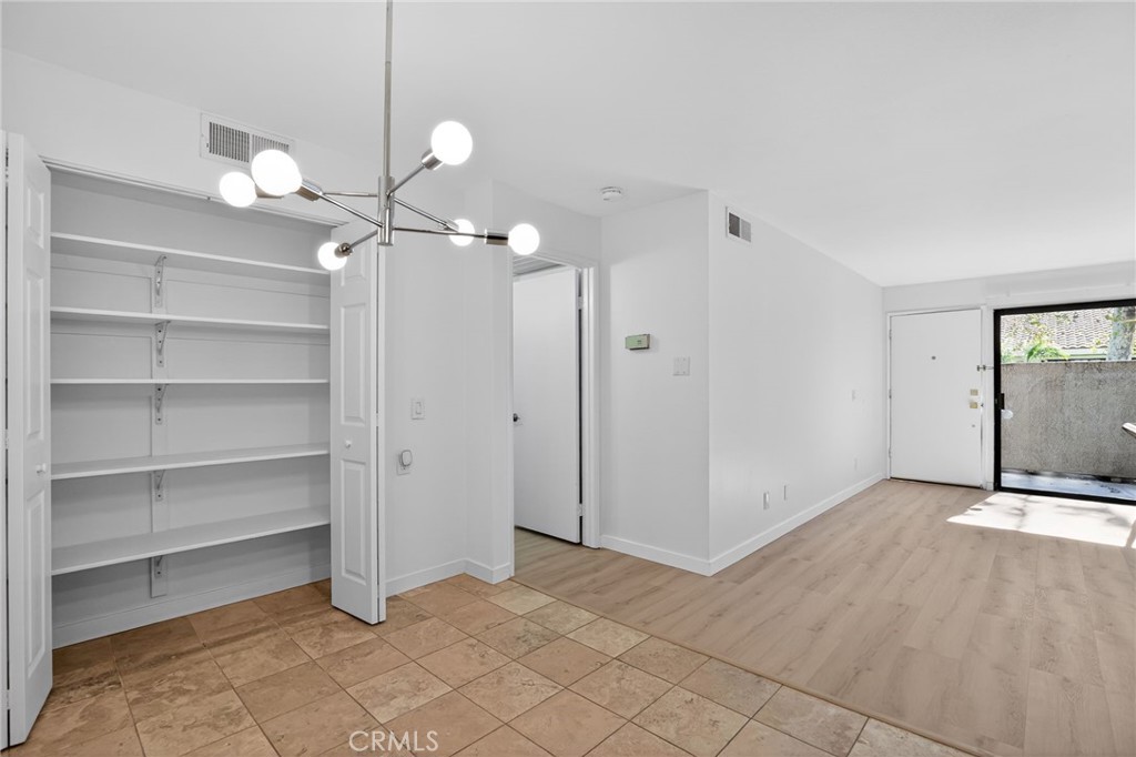18808 Mandan Street, Unit 309 Canyon Country, CA 91351 - Photo 11 of 19 a view of an empty room with a mirror and fan