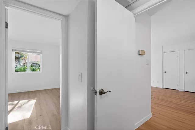 a view of a hallway with wooden floor