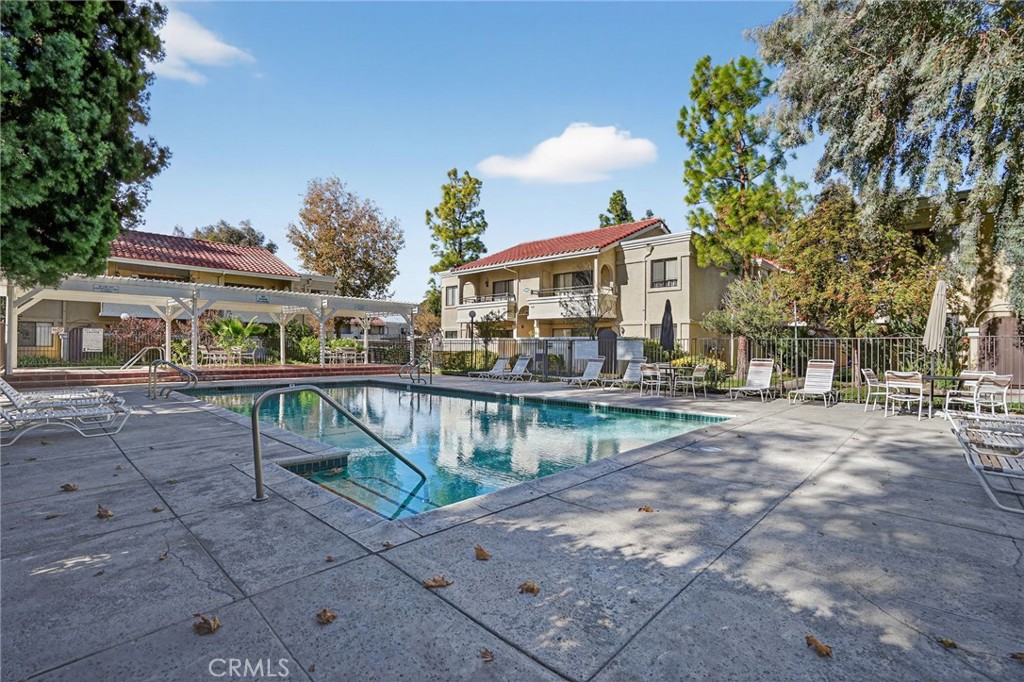 18808 Mandan Street, Unit 309 Canyon Country, CA 91351 - Photo 15 of 19 a view of house with outdoor seating area and trees