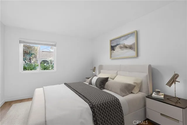 a bedroom with a bed and a painting on the wall