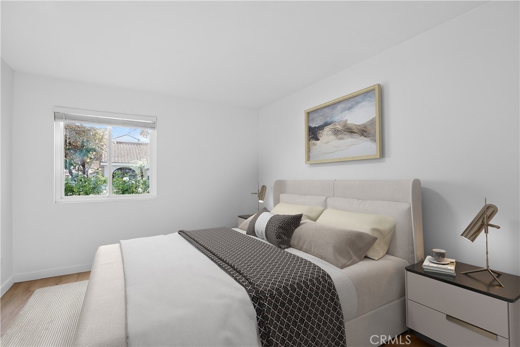 18808 Mandan Street, Unit 309 Canyon Country, CA 91351 - Photo 3 of 19 a bedroom with a bed and a painting on the wall