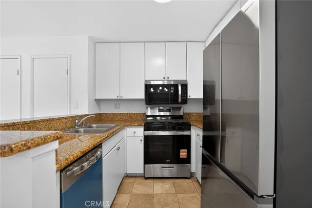 a kitchen with a sink stove and refrigerator