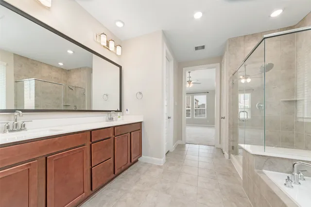 a bathroom with a granite countertop sink a toilet and shower