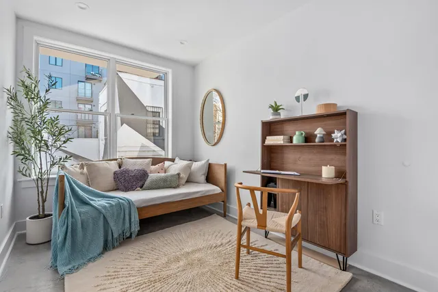 a view of a dining room with furniture and a potted plant