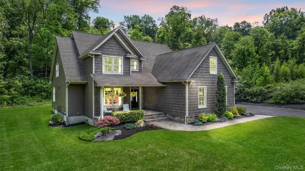 a front view of a house with a yard and porch