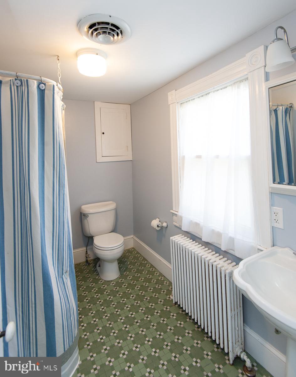 606 Locust Street Cambridge, MD 21613 - Photo 29 of 37 a bathroom with a toilet a sink and a window
