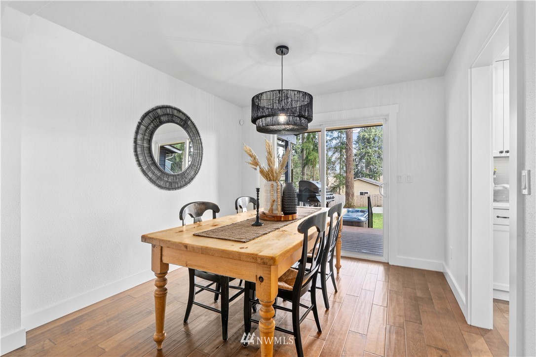 909 Harvest Road Bothell, WA 98012 - Photo 8 of 37 a view of a dining room with furniture window and outside view