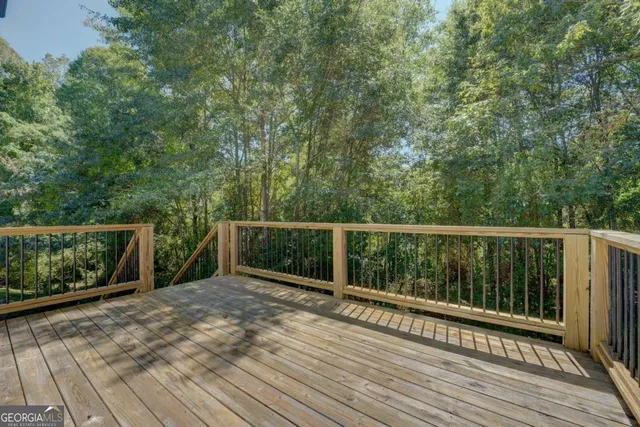 a balcony with wooden floor and fence