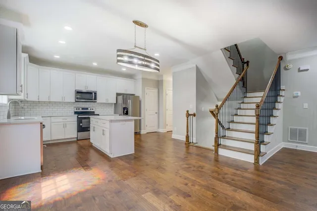 a view of kitchen with sink microwave and stove