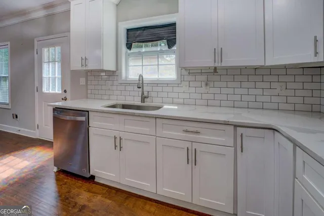 a kitchen with a sink cabinets and window