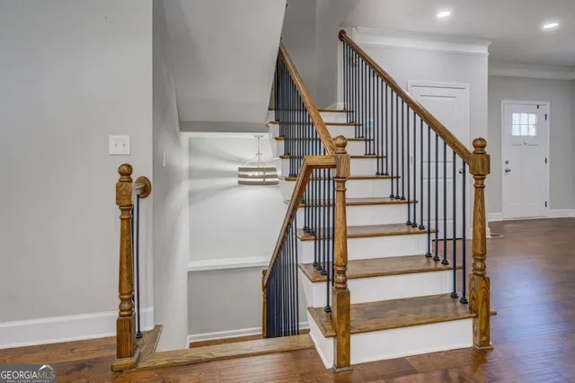 a view of entryway with wooden floor and stairs