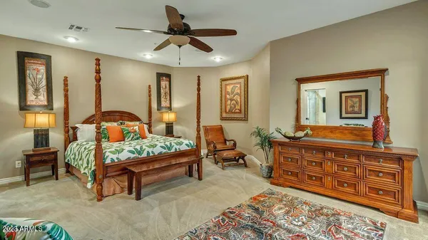 a bedroom with a bed a dresser and a window