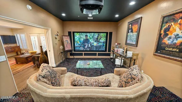 a large white couch sitting in a living room next to a window