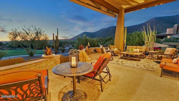 an outdoor space with swimming pool and furniture