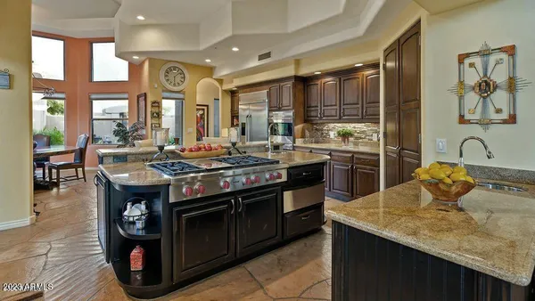 a kitchen with stainless steel appliances granite countertop sink stove and cabinets